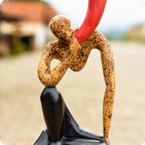 A Carved Sculpture Of A Horn Blower