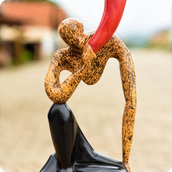 A Carved Sculpture Of A Horn Blower - Image 2