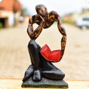 Carved Sculpture Of A Thinking Man With Book